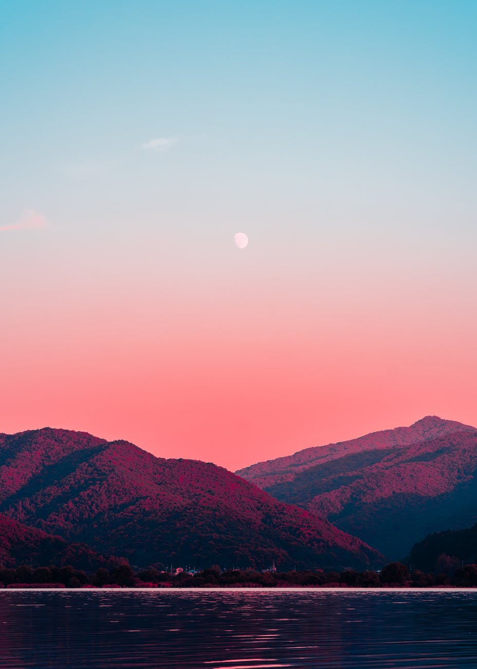 photography of body of water and mountains