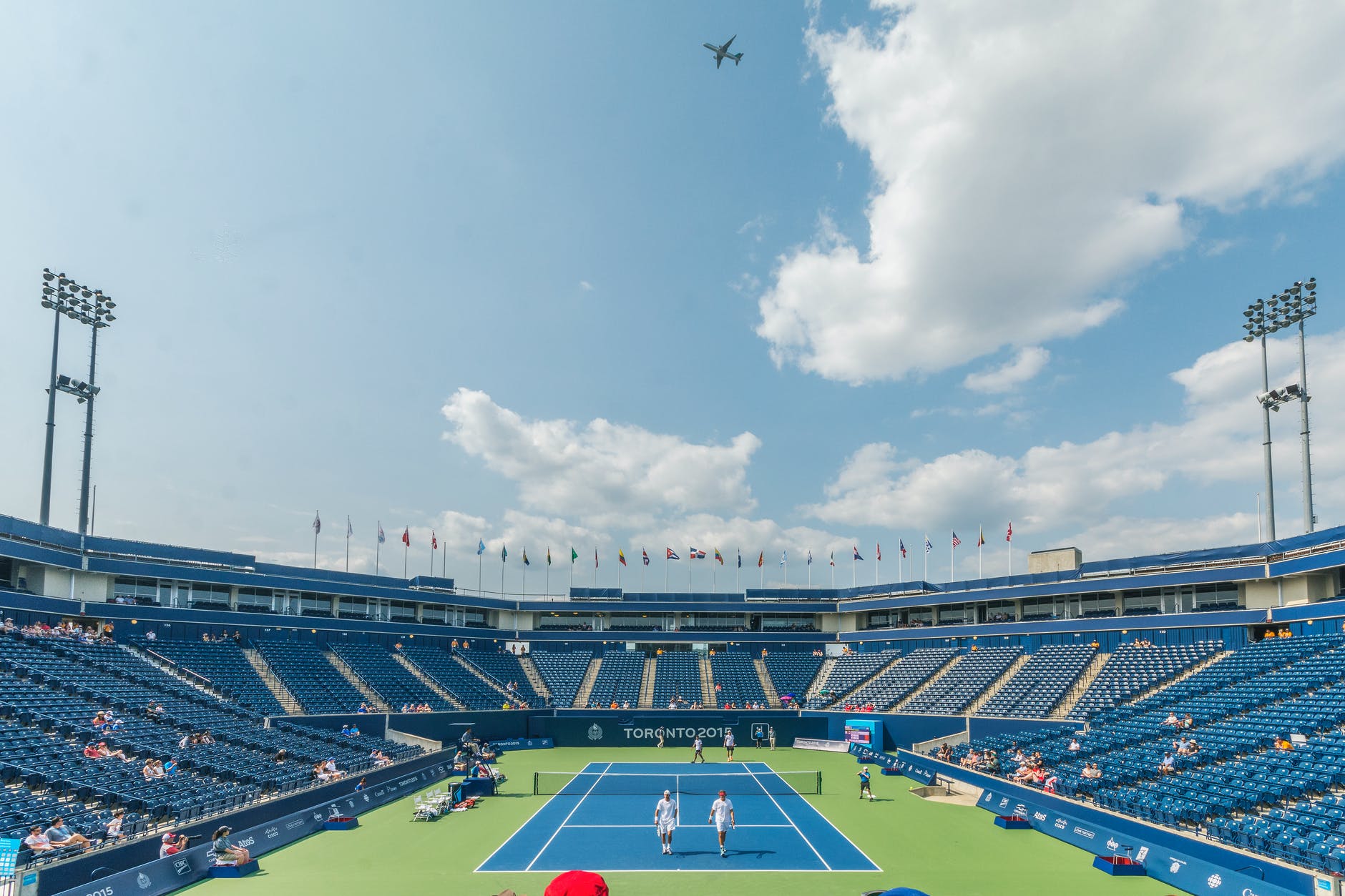 people standing on blue and green tennis court