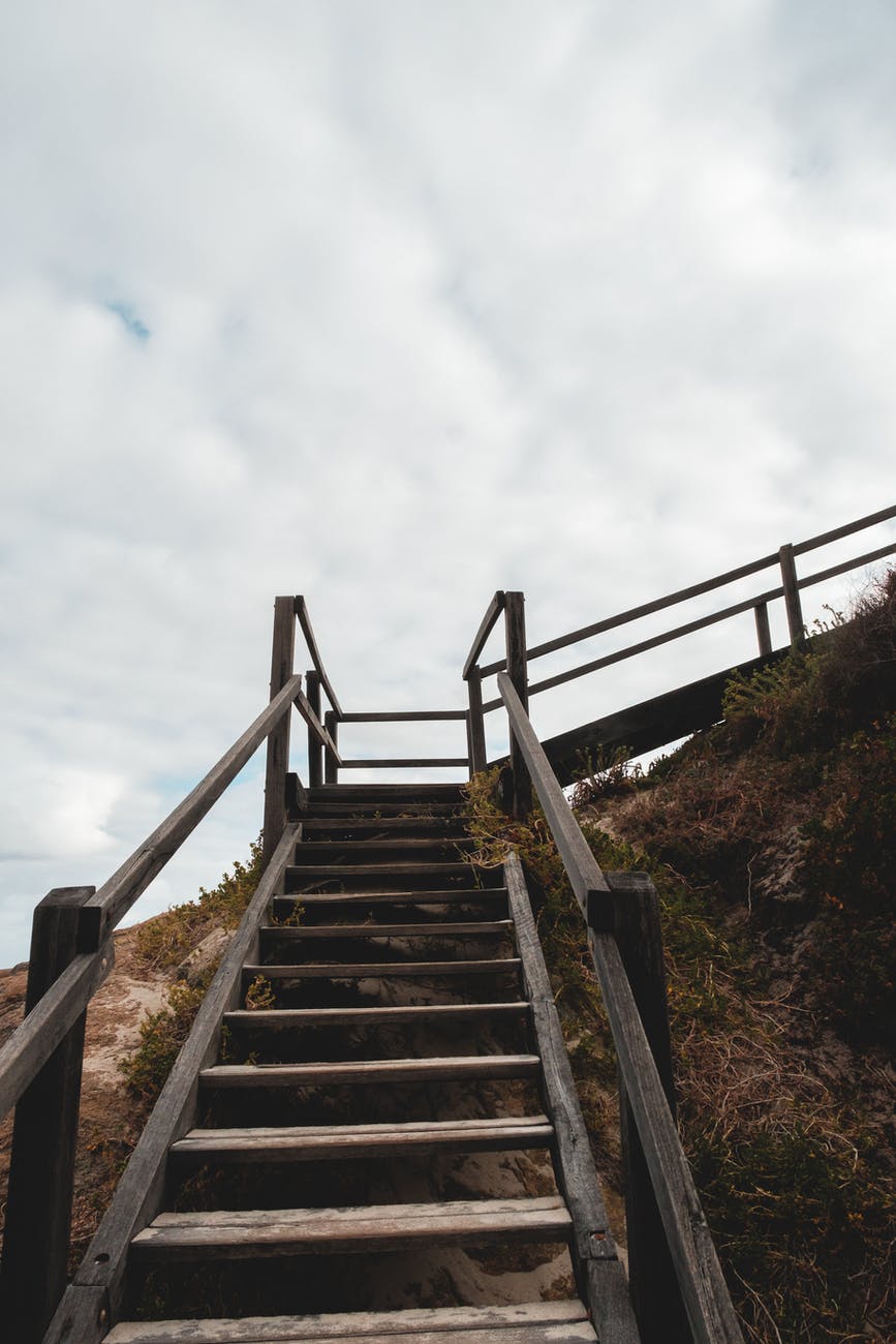 wooden staircase on stony cliff slope