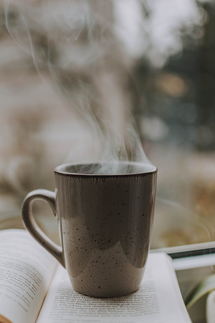 photo of coffee mug on top of book