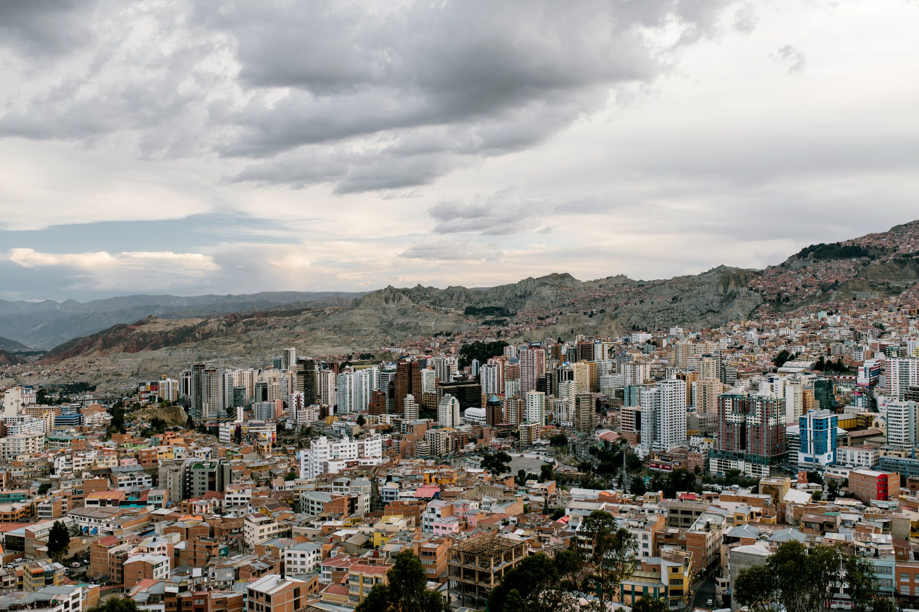 aerial view of city buildings under cloudy sky