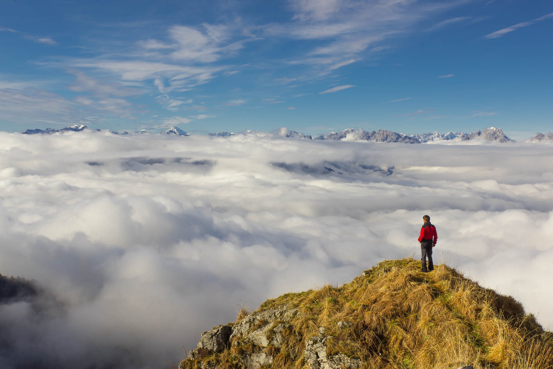 man standing on mountain against sky