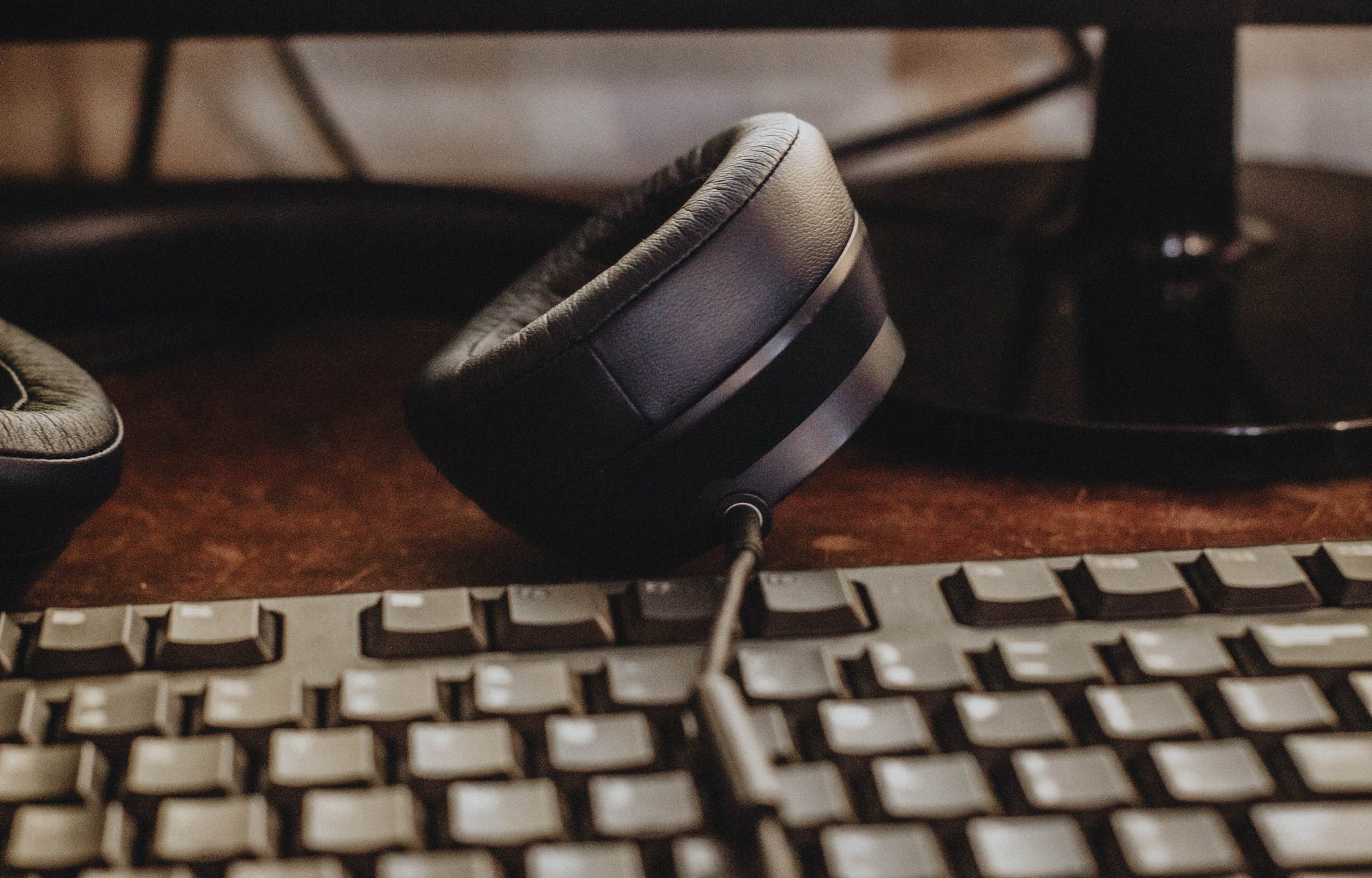 black headphones and keyboard on the desk