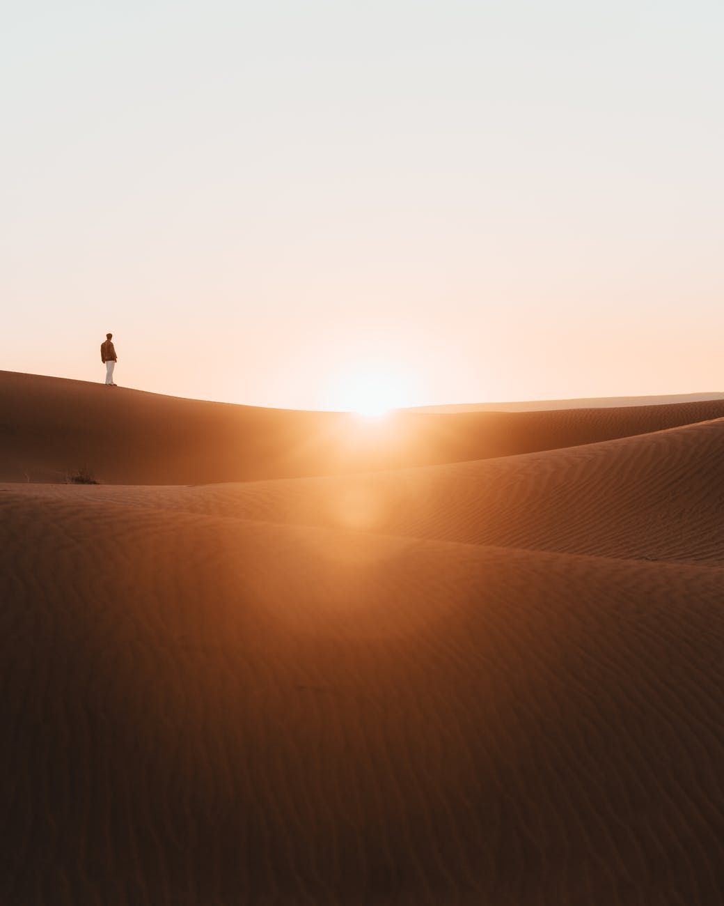 person walking on desert