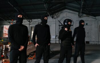 people wearing all black outfit and black balaclava